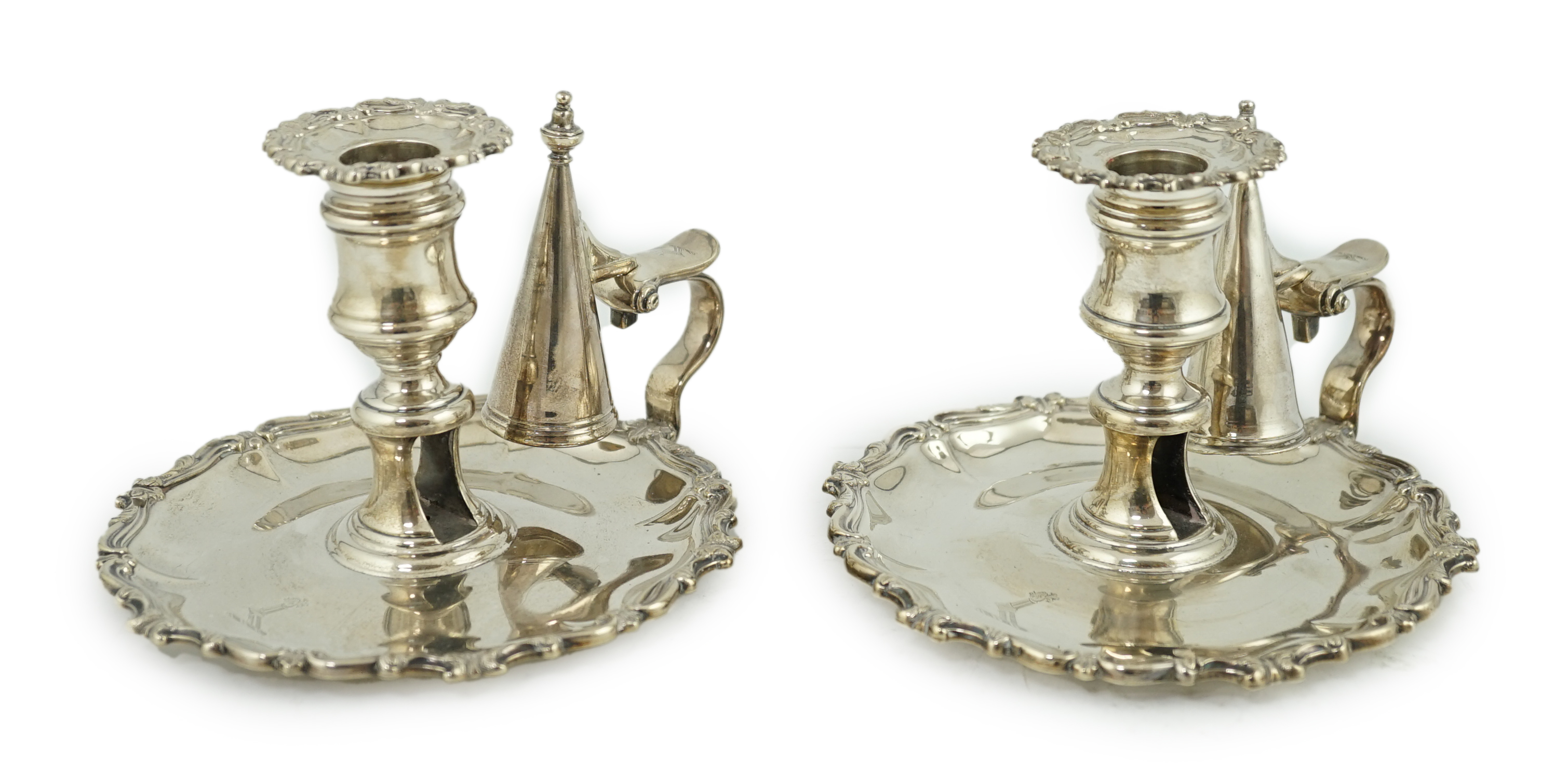 A pair of William IV silver chambersticks and extinguishers, by Creswick & Co